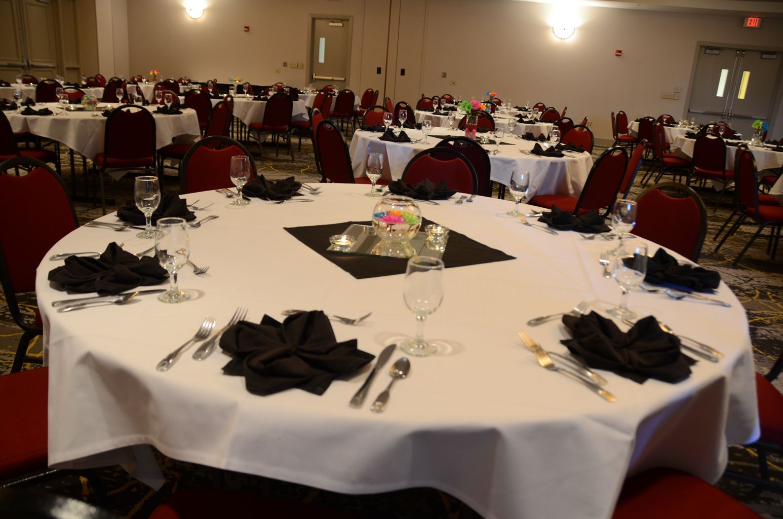 A large room with tables and chairs set up for a banquet