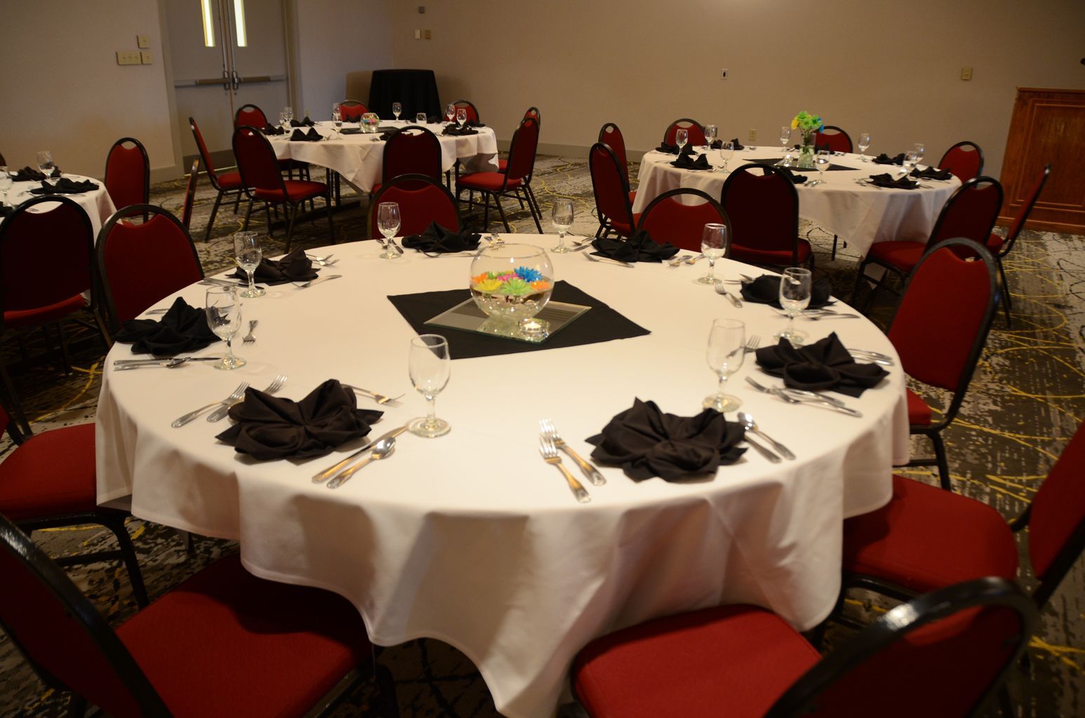 A room with tables and chairs set up for a party