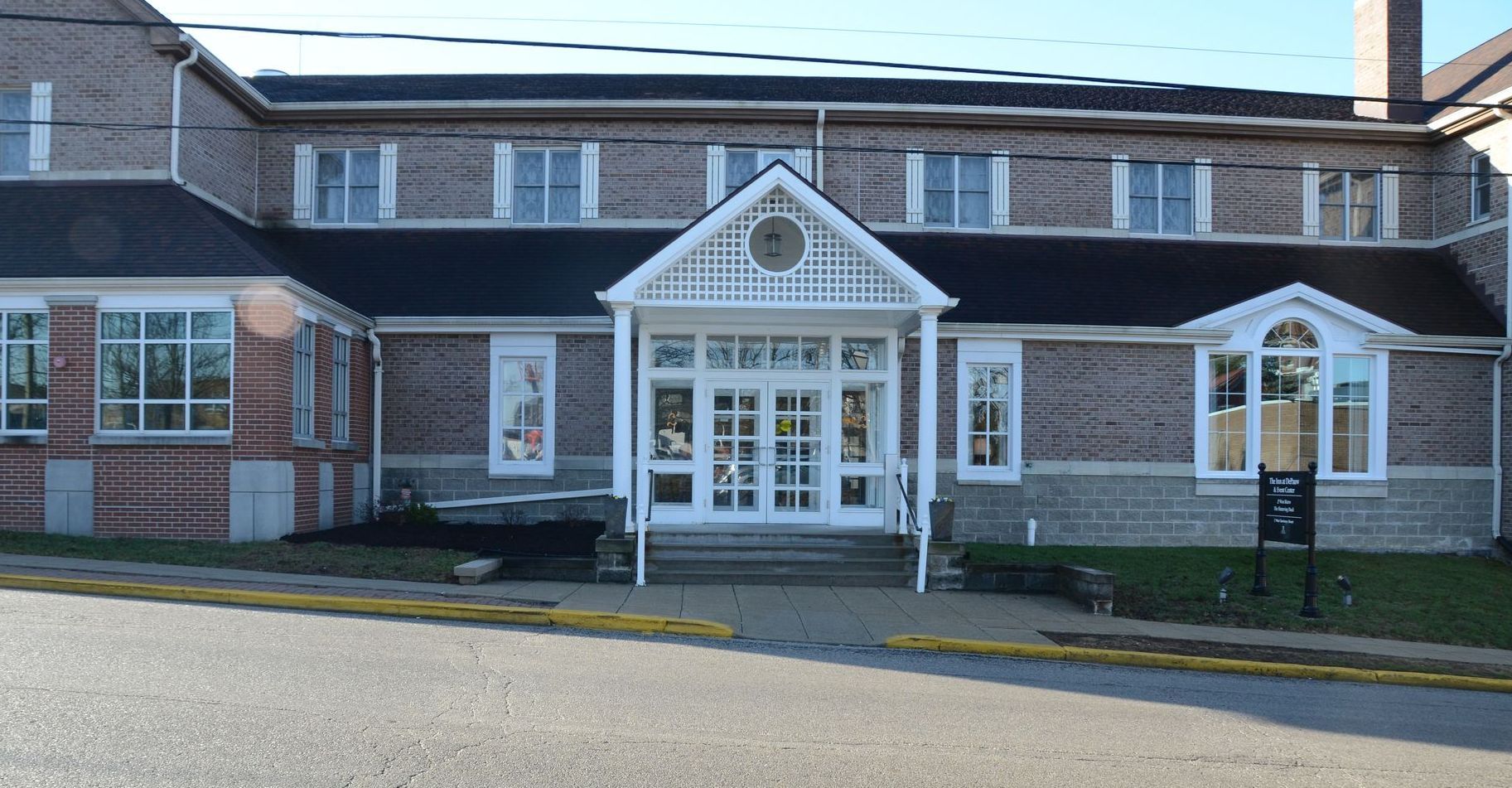 A large brick building with a clock on the front of it