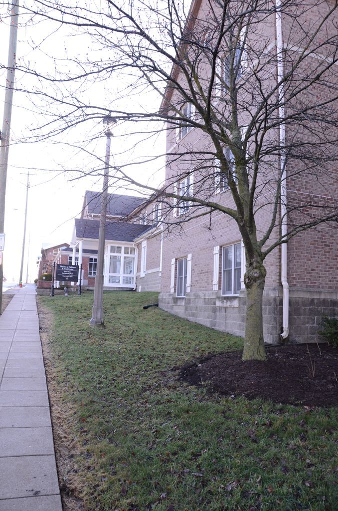 A brick building with a tree in front of it