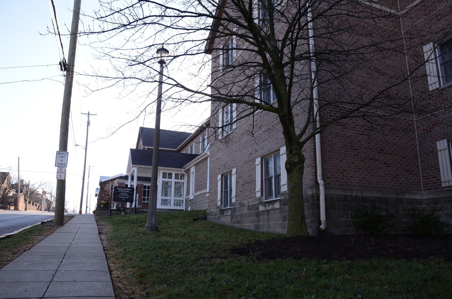 A brick building with a tree in front of it
