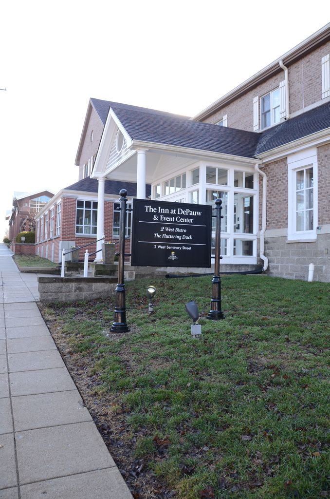 A large brick building with a sign in front of it.