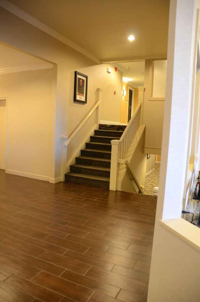 A hallway with stairs leading up to the second floor of a house.