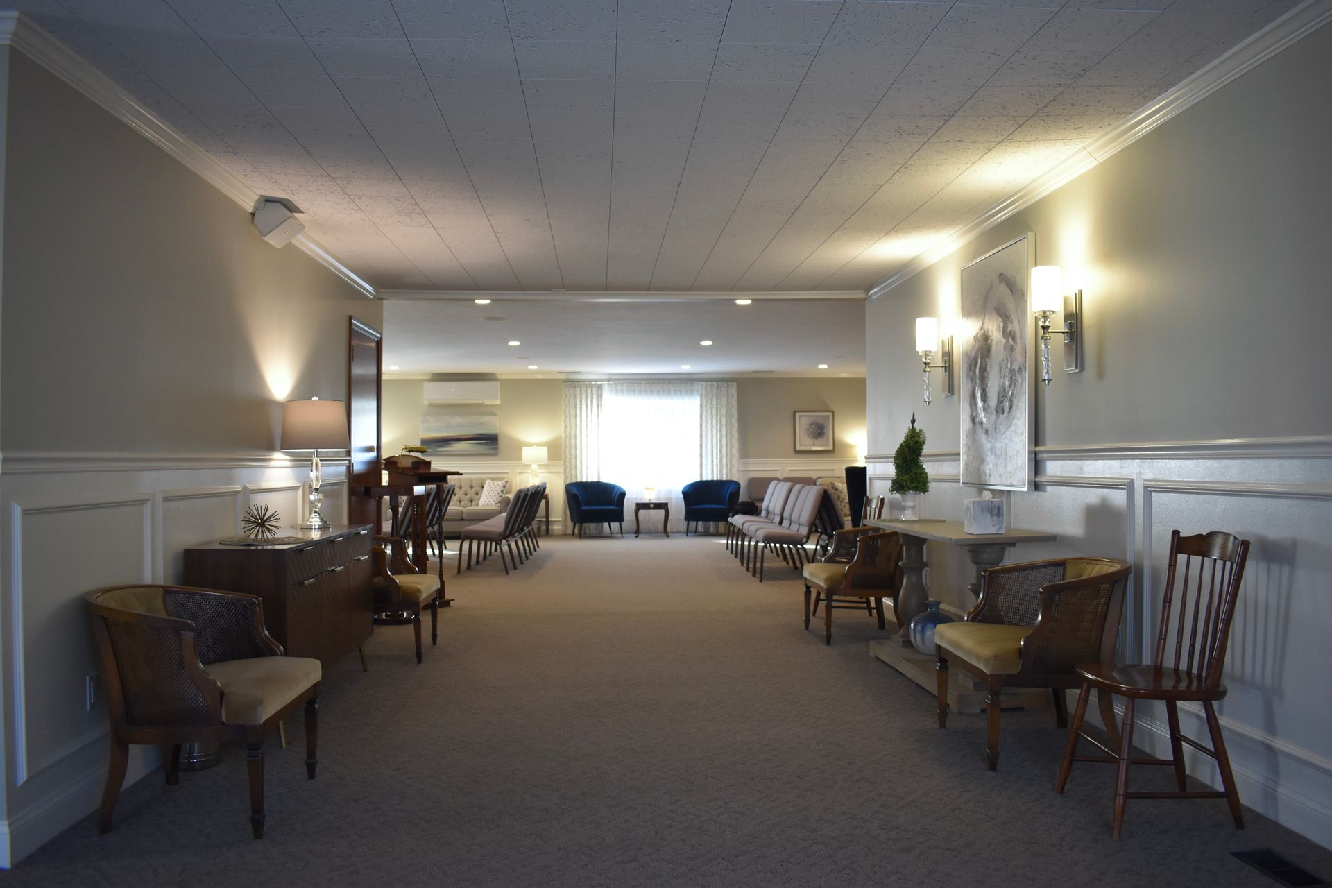 A hallway with a lot of chairs and tables