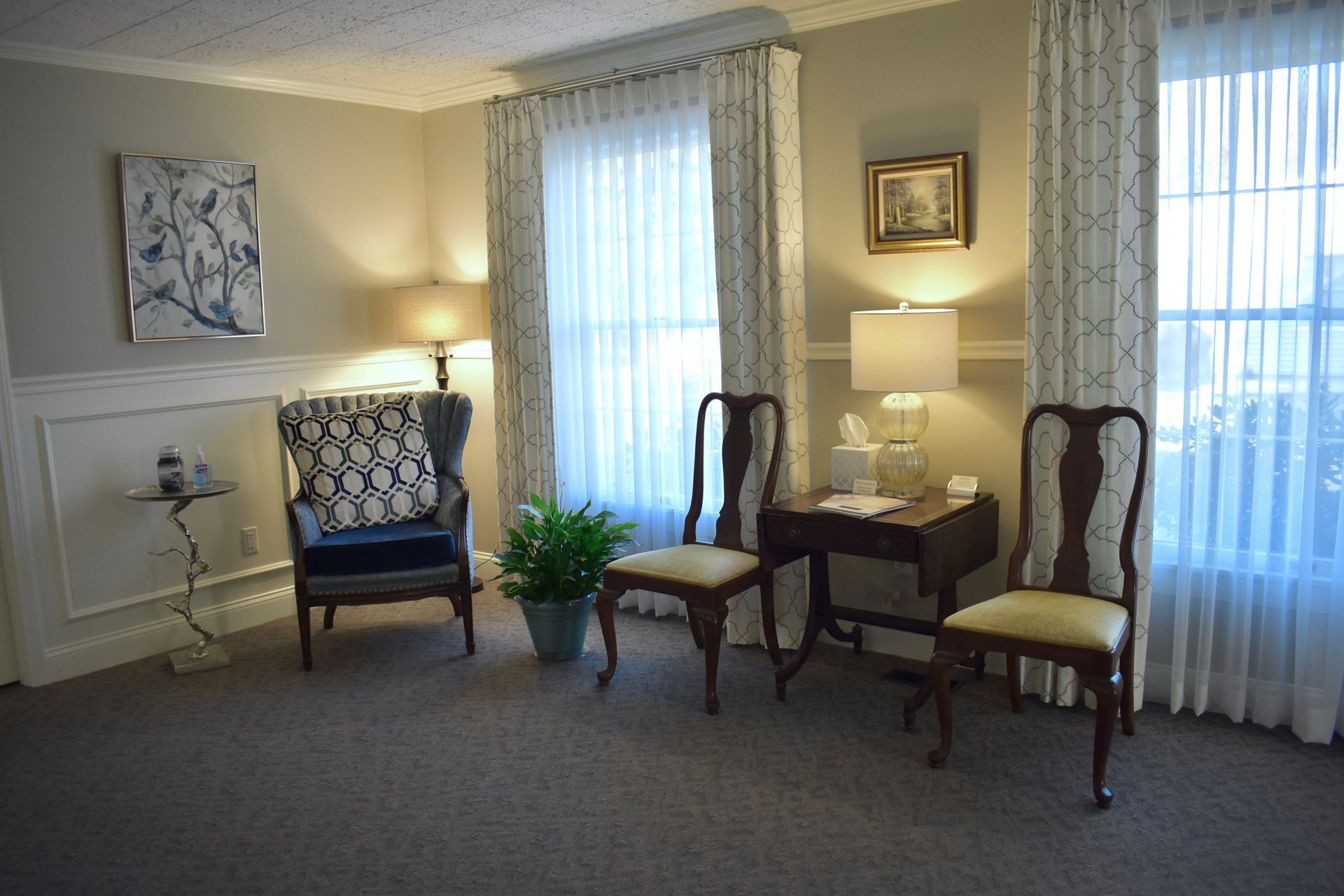 There are two chairs and a table in the room.