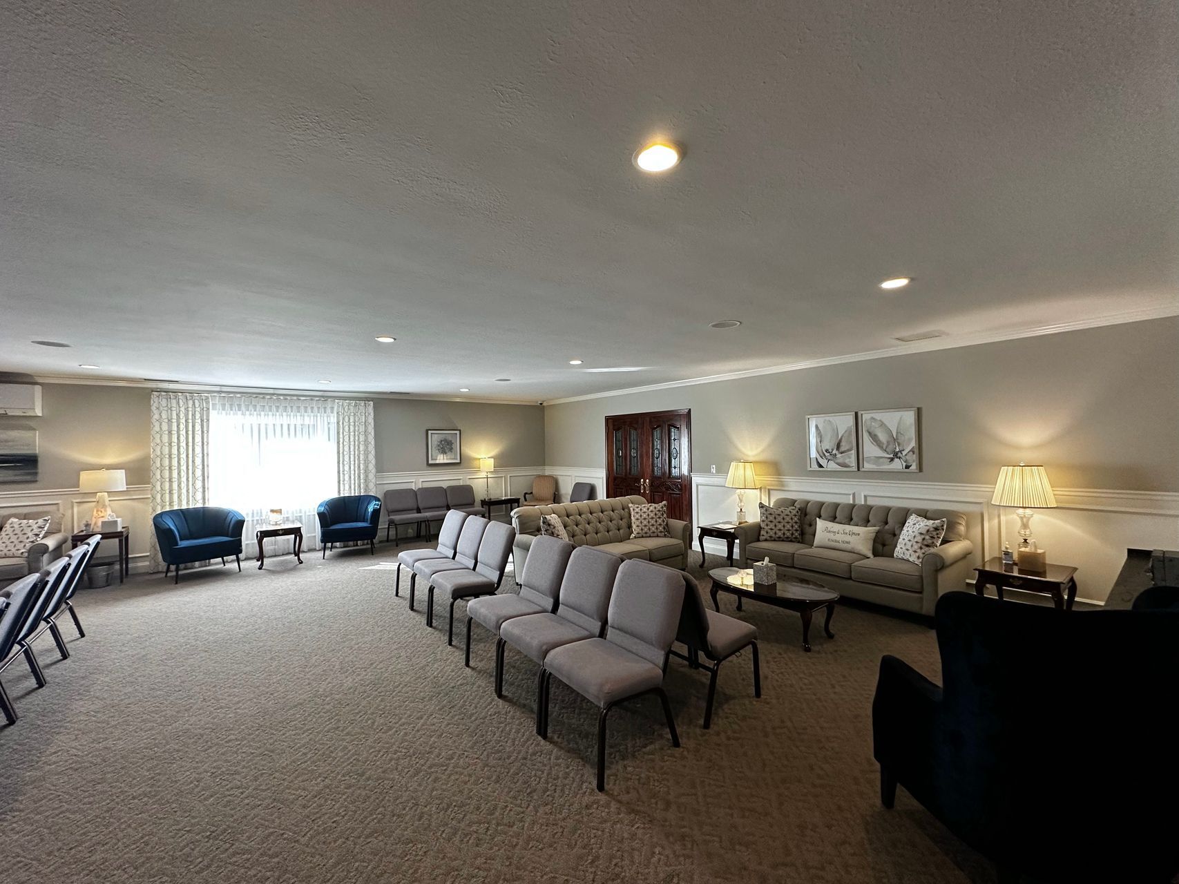 A large living room filled with furniture and chairs.