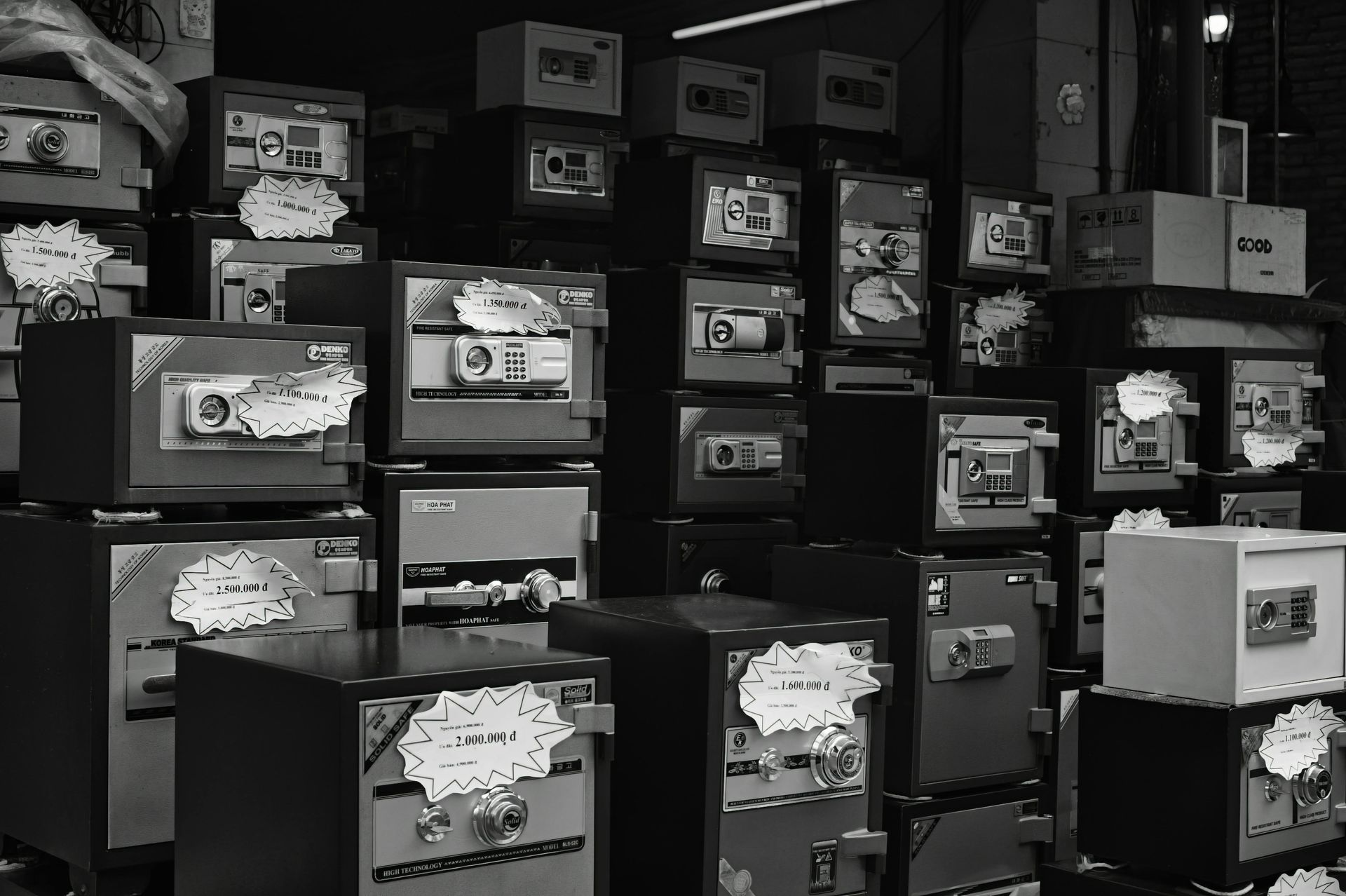 A black and white photo of a bunch of safes stacked on top of each other.