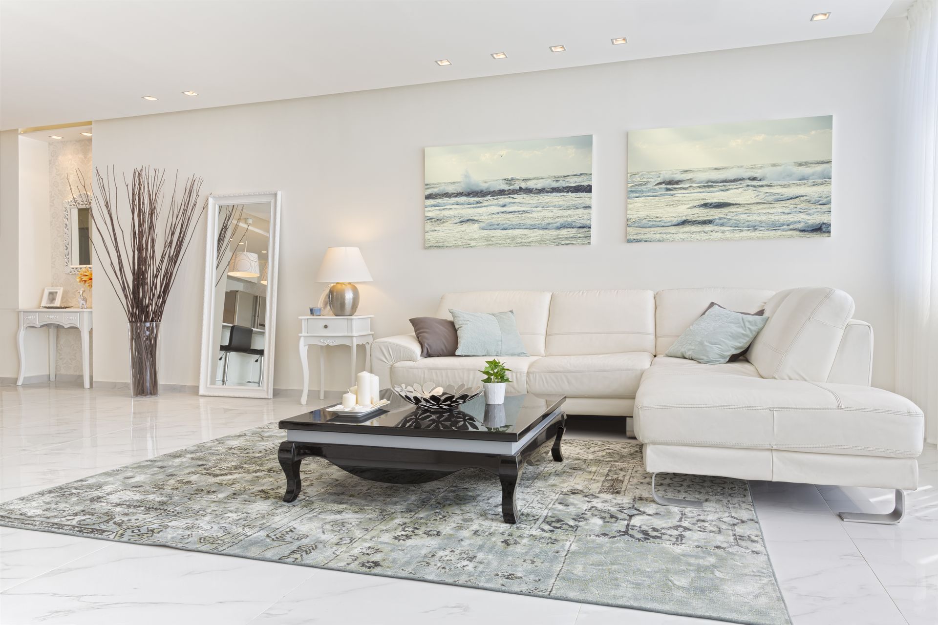 A living room with a white sectional couch and a coffee table.
