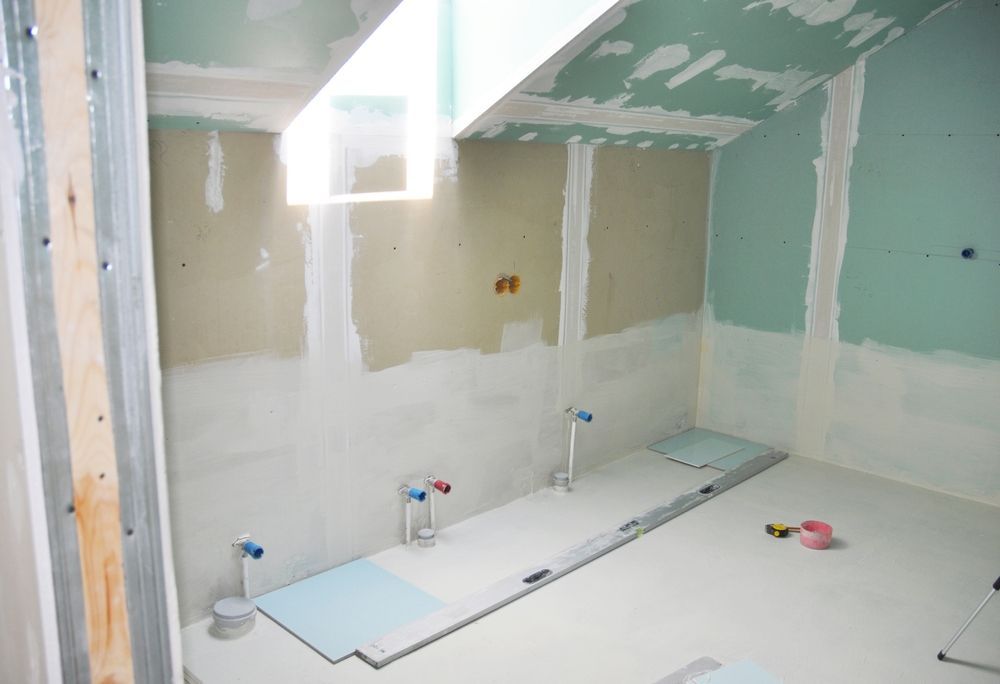 A bathroom under construction with a ceiling that is very high