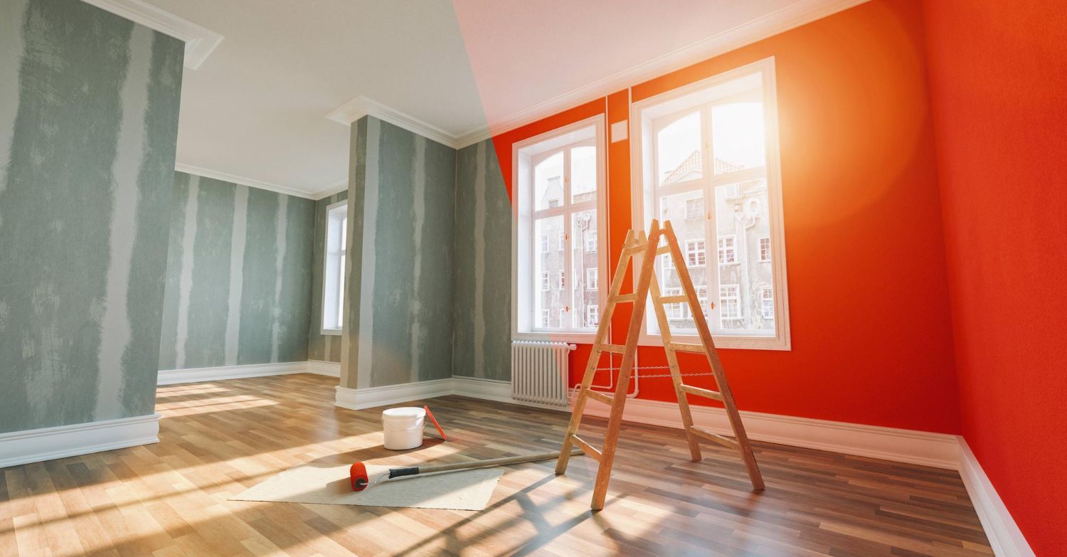 Freshly painted room with striped walls, bright orange accent wall, and a ladder by the windows.