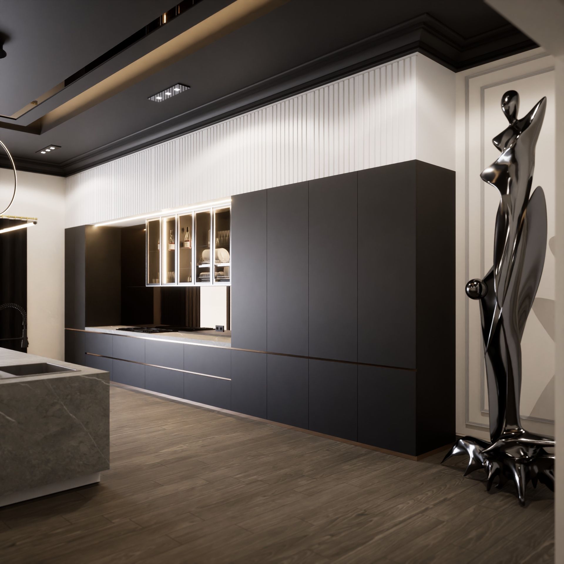 A kitchen with black cabinets and a statue on the wall