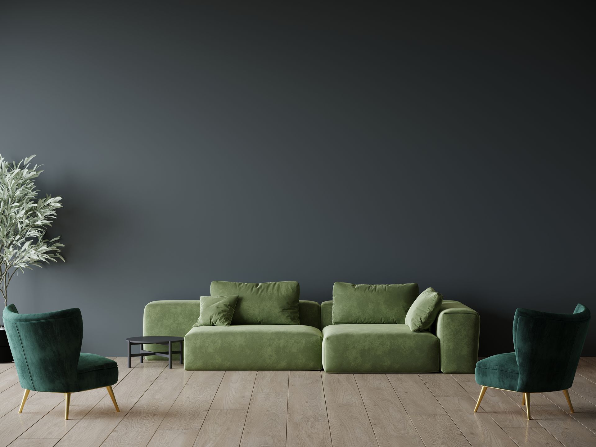 A newly painted living room with a green couch and two green chairs.