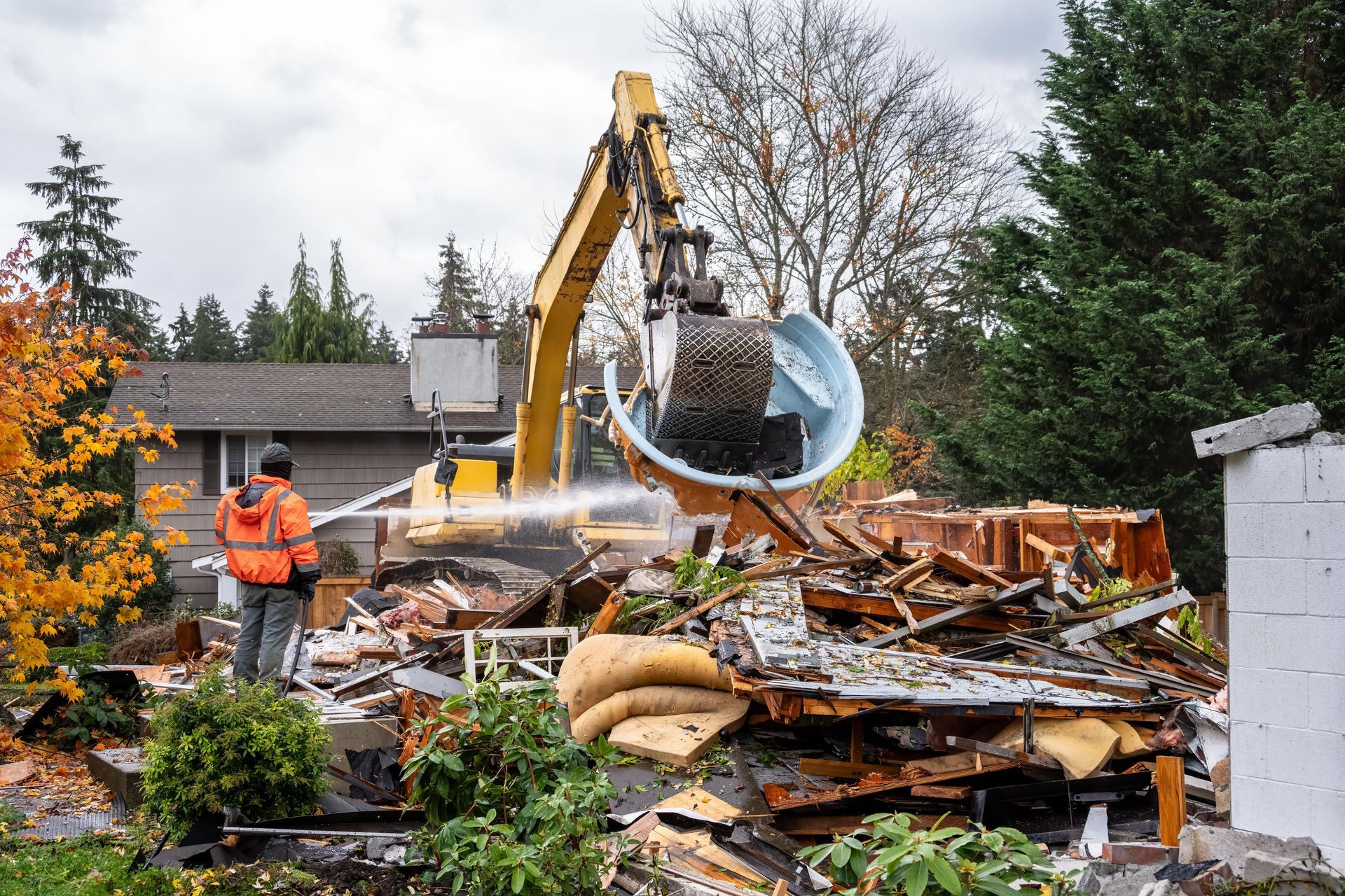 A house is being demolished by a bulldozer.
