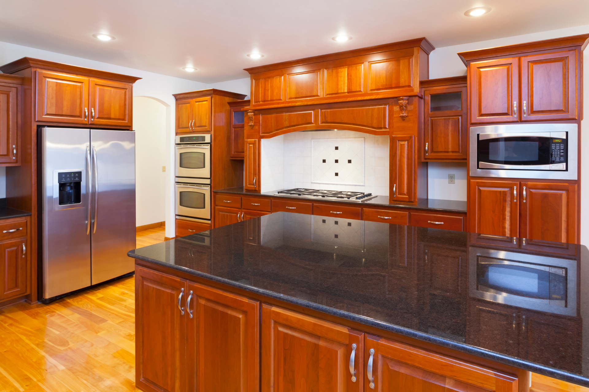 A kitchen with stainless steel appliances and wooden cabinets