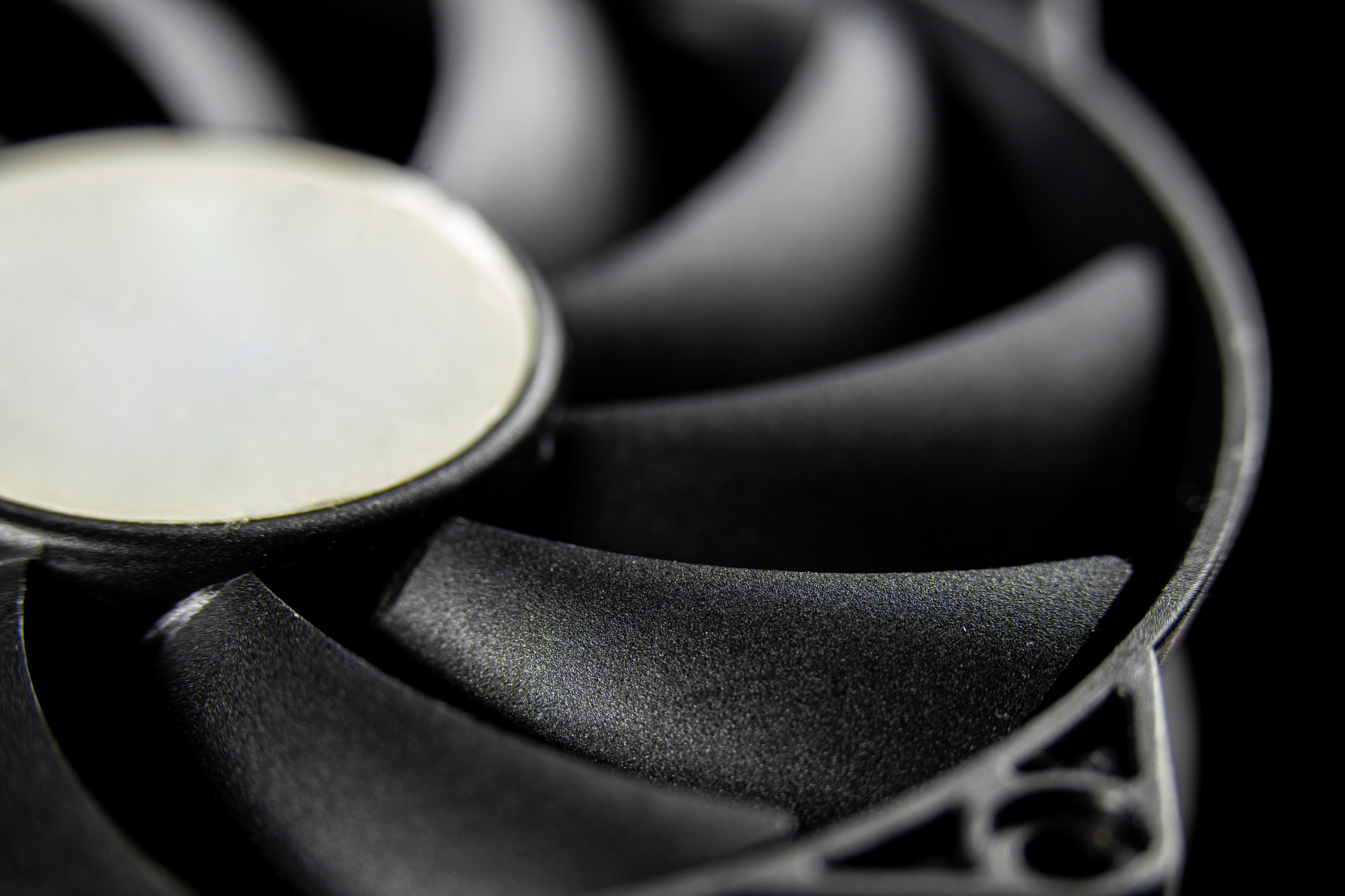 A close up of a computer fan on a black background