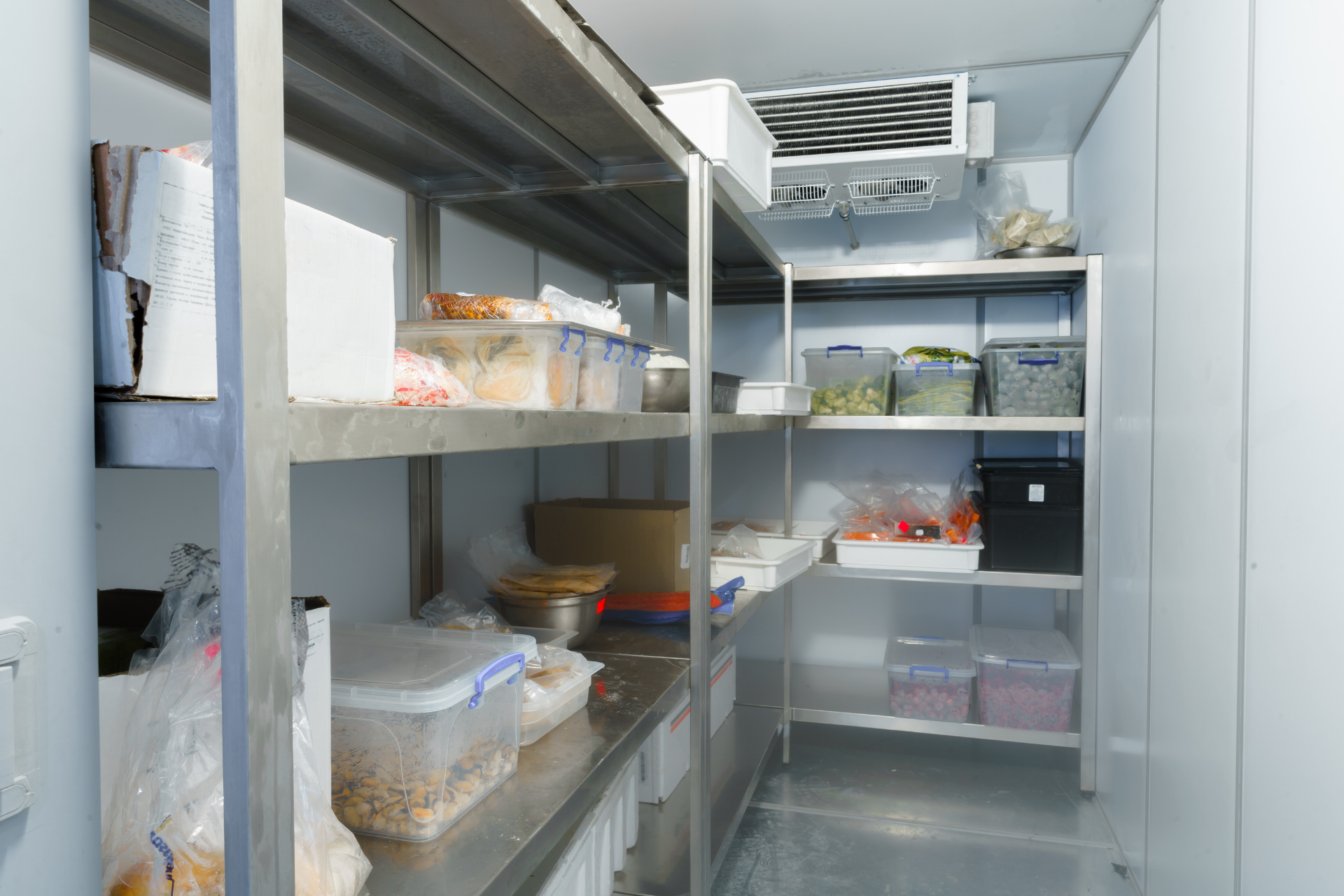 A freezer filled with lots of food and shelves.
