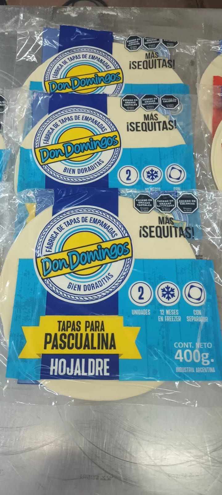 Paquete de tapas para pascualina marca “Don Domingo”. Envase azul, blanco y amarillo con el nombre del producto.