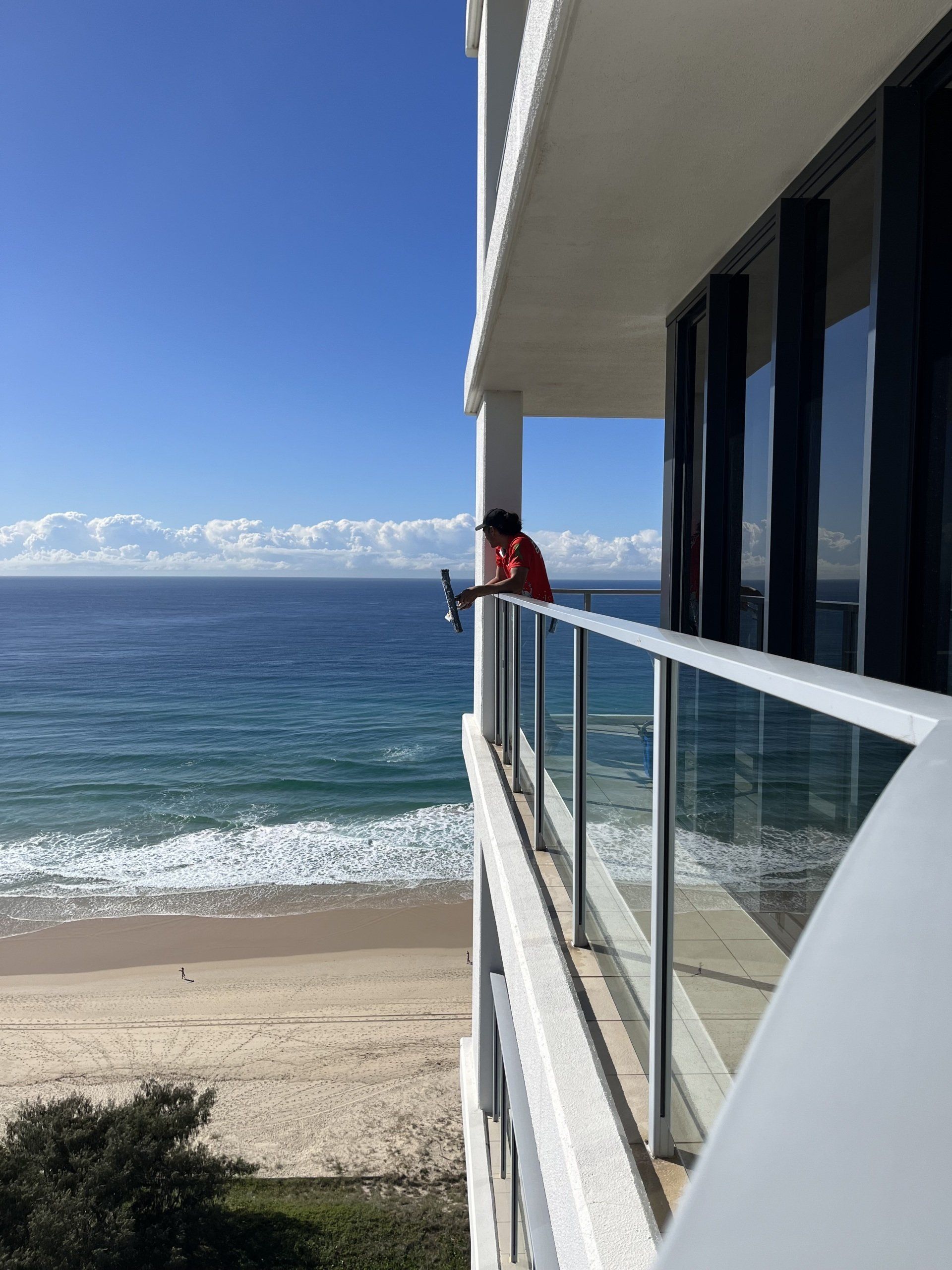 Window Cleaner Looking Out Over Ocean — Jackson’s Window Cleaning in Nerang, QLD