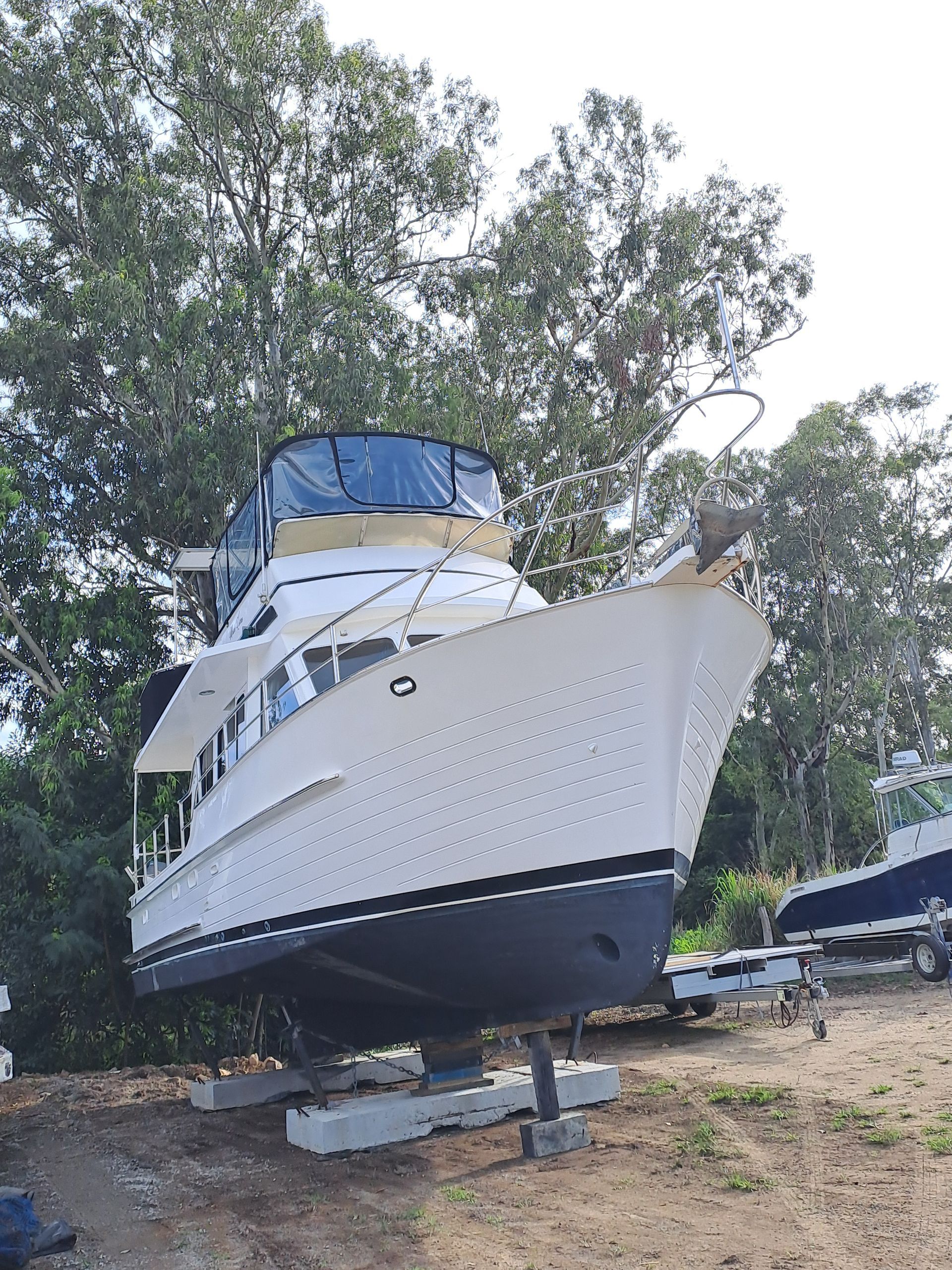 A Large Boat Is Being Lifted By A Crane — Edge's Boatyard In Jubilee Pocket, QLD