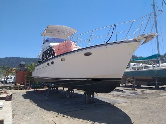A Large White Boat Is Parked In A Parking Lot — Edge's Boatyard In Jubilee Pocket, QLD