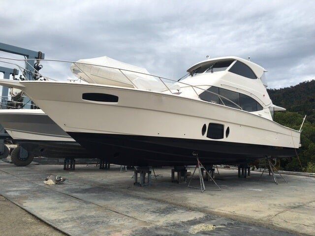A Large White Boat With A License Plate That Says Kingo — Edge's Boatyard In Jubilee Pocket, QLD