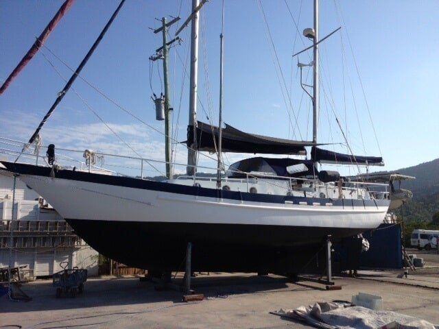 A Black And White Sailboat With The Letters W.c. On The Side — Edge's Boatyard In Jubilee Pocket, QLD