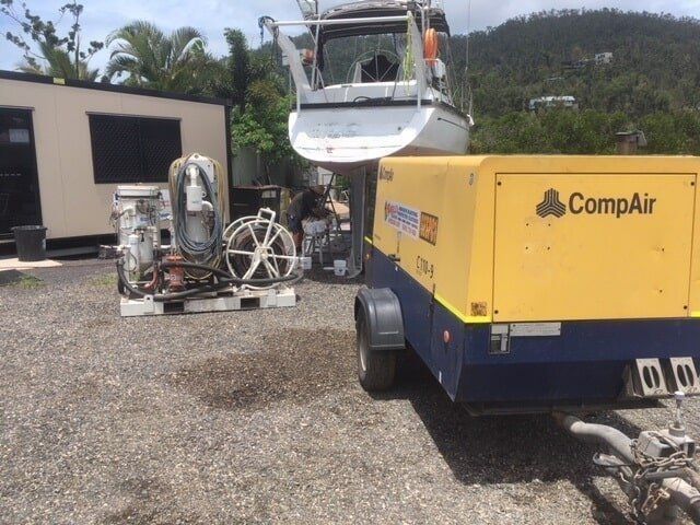 A Yellow And Blue Compressor Is Parked Next To A Boat — Edge's Boatyard In Jubilee Pocket, QLD