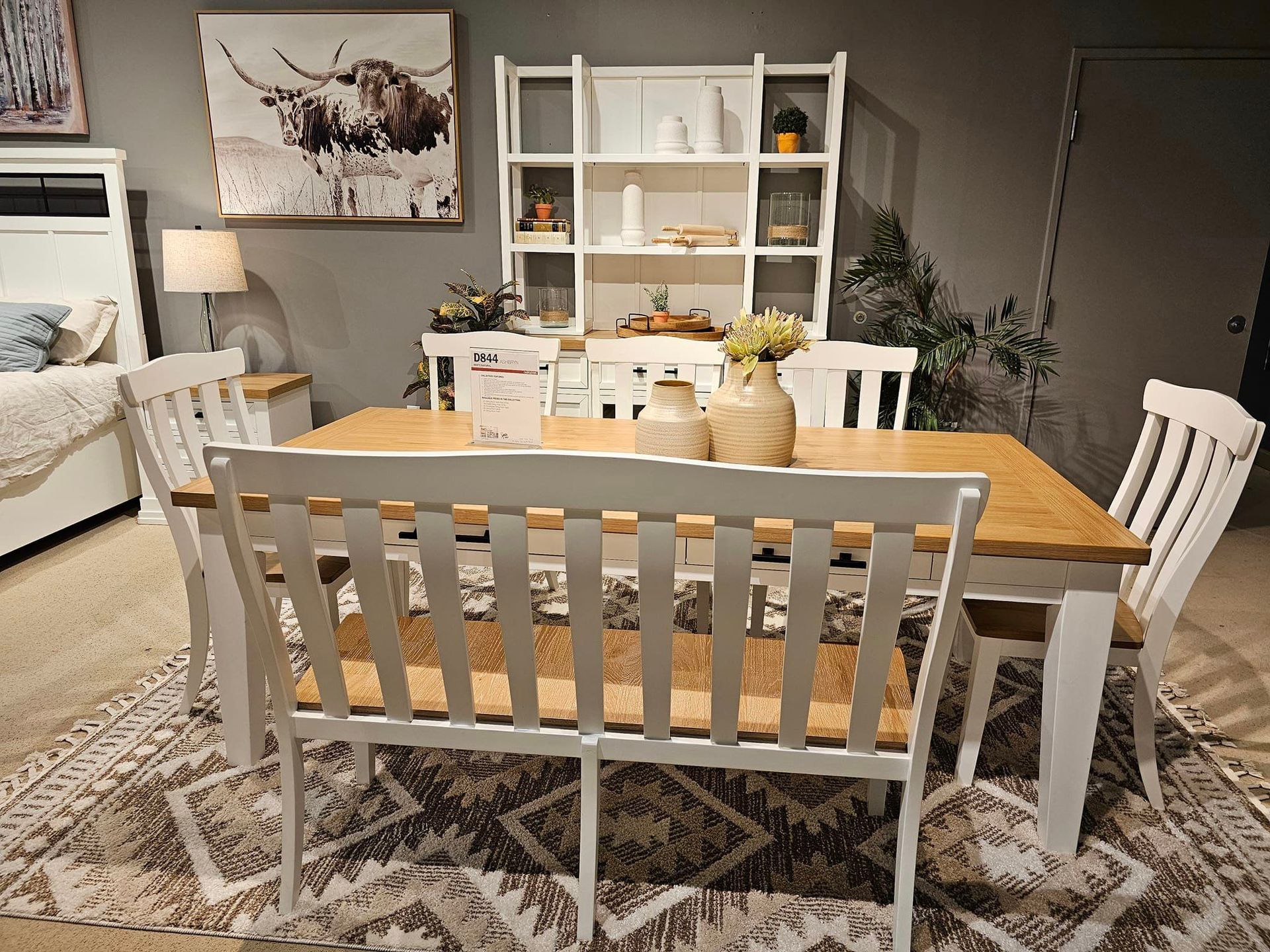 A white dining table and chairs are sitting on a rug in a dining room - Montclair, CA - Alexa Furniture