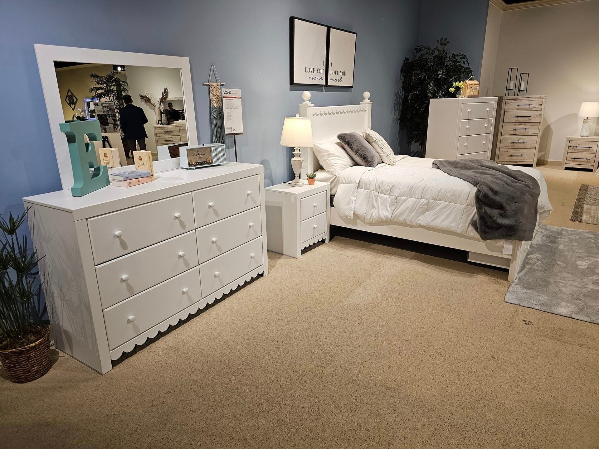 A blue couch with pillows on it is in a living room - Montclair, CA - Alexa Furniture