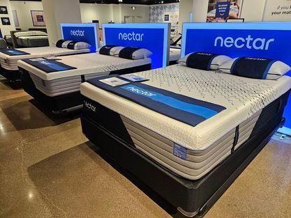 A white dining table and chairs are sitting on a rug in a dining room - Montclair, CA - Alexa Furniture