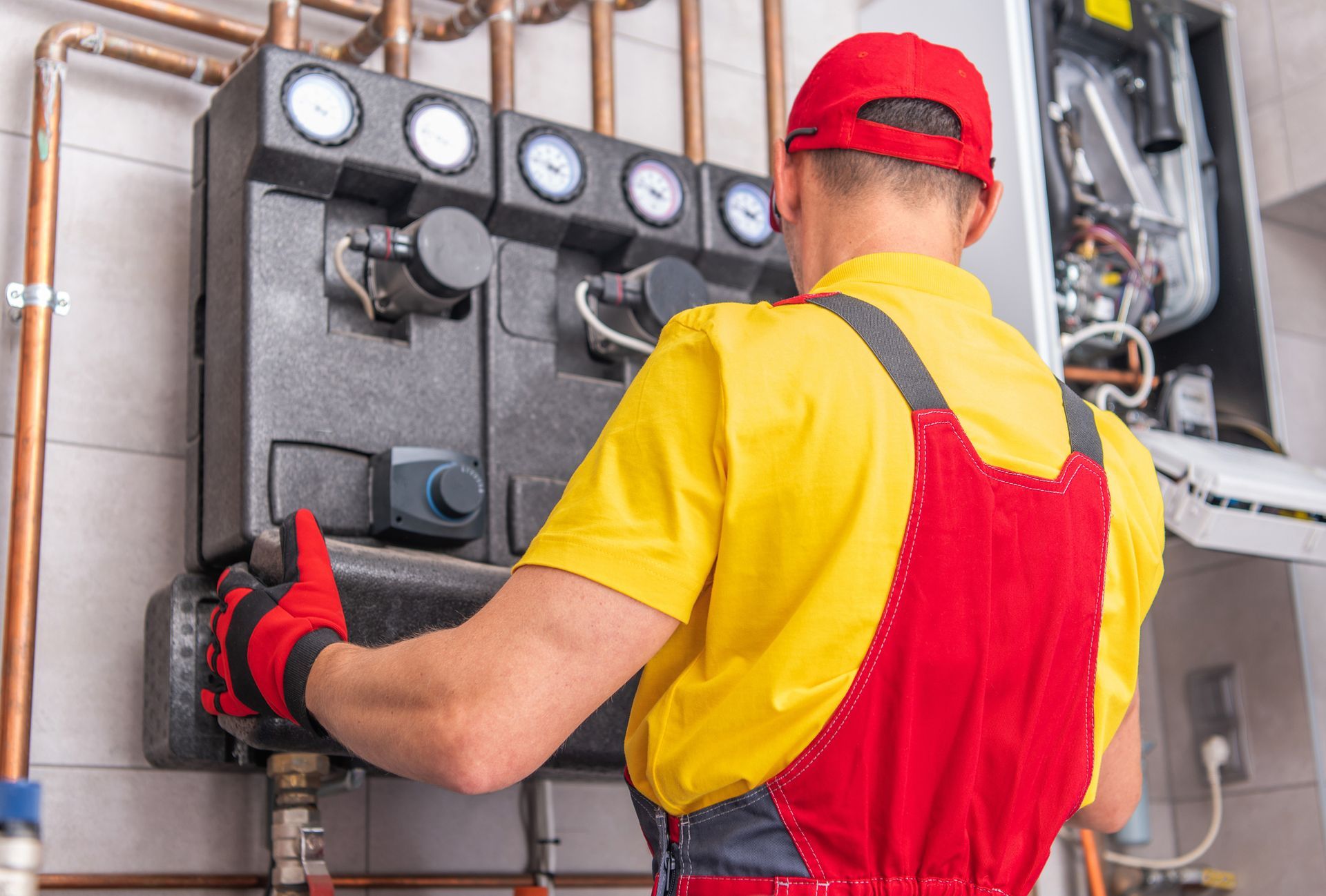 Experienced plumbing contractor installing a water heating system for a commercial building.