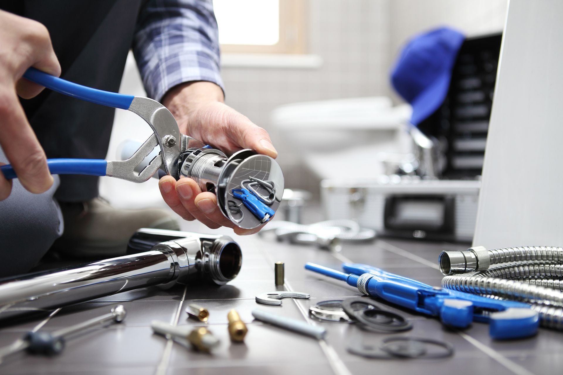 An experienced plumber installing bathroom fixtures.