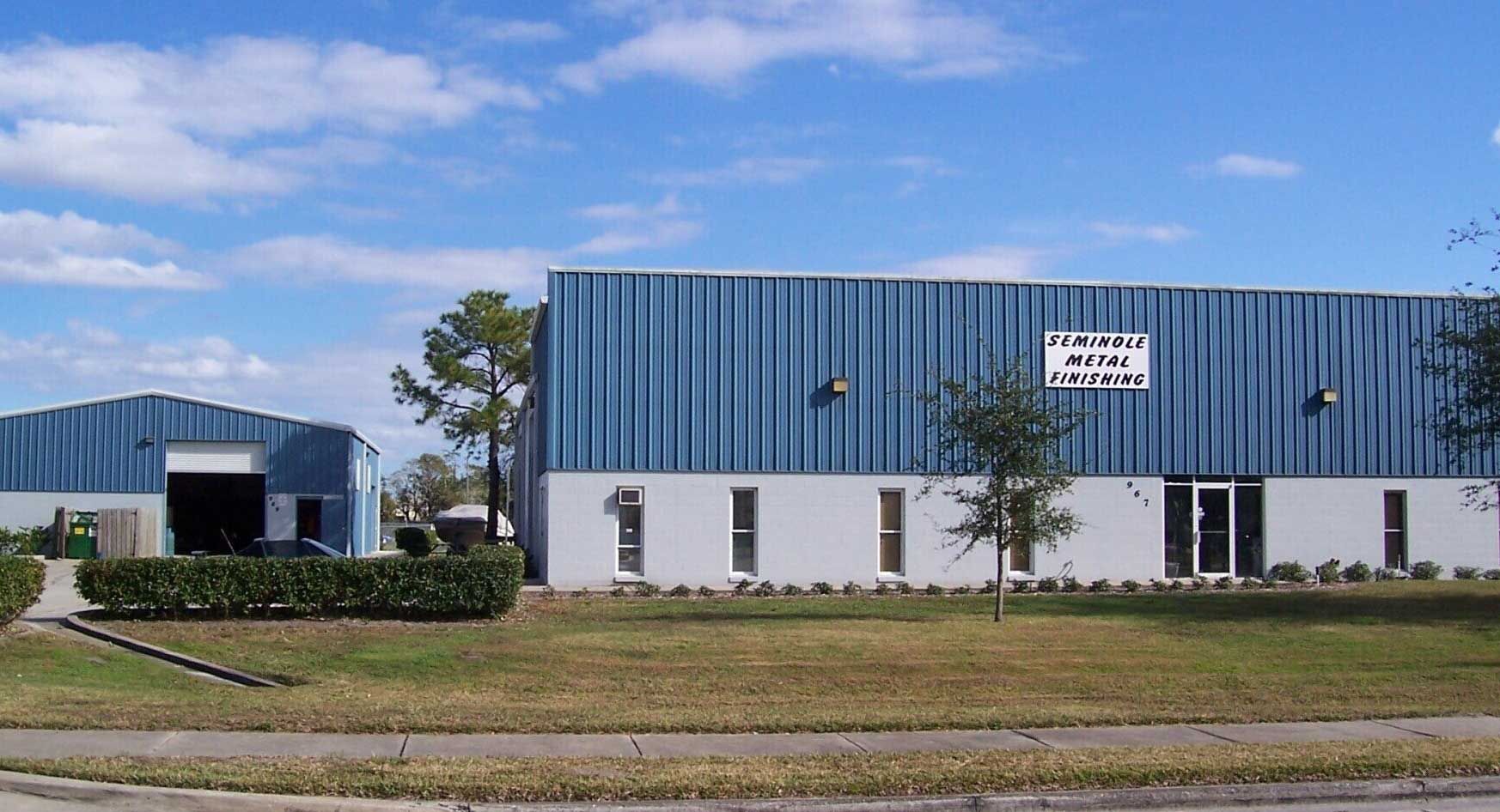 A blue and white building with a sign on the side that says ' warehouse '