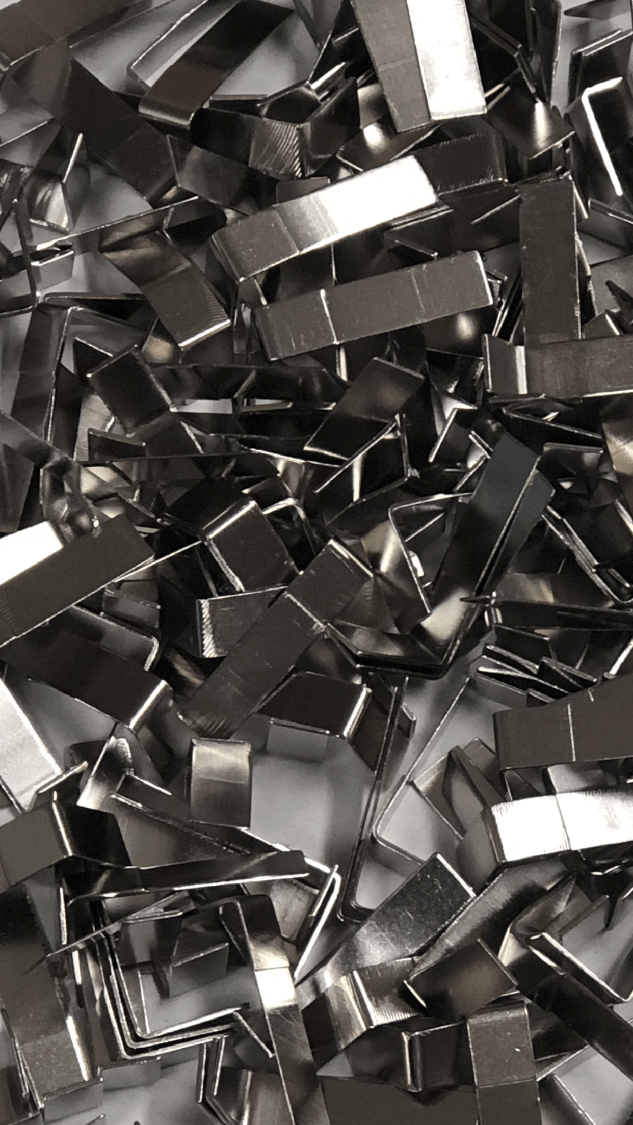 A close up of a pile of metal pieces on a table.