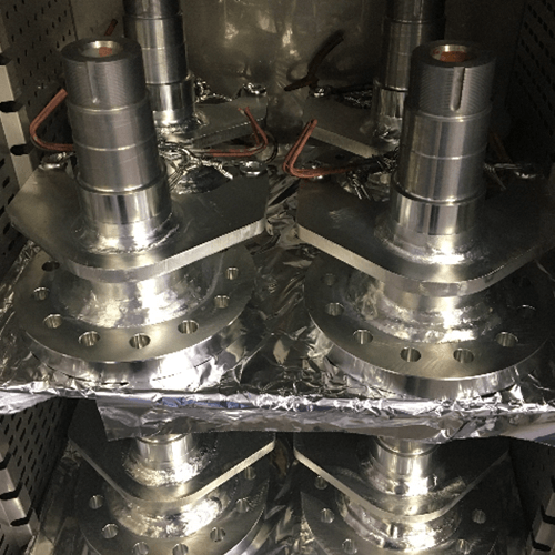 Steel hubs in a baking oven after they have been zinc plated by Seminole Metal Finishing.
