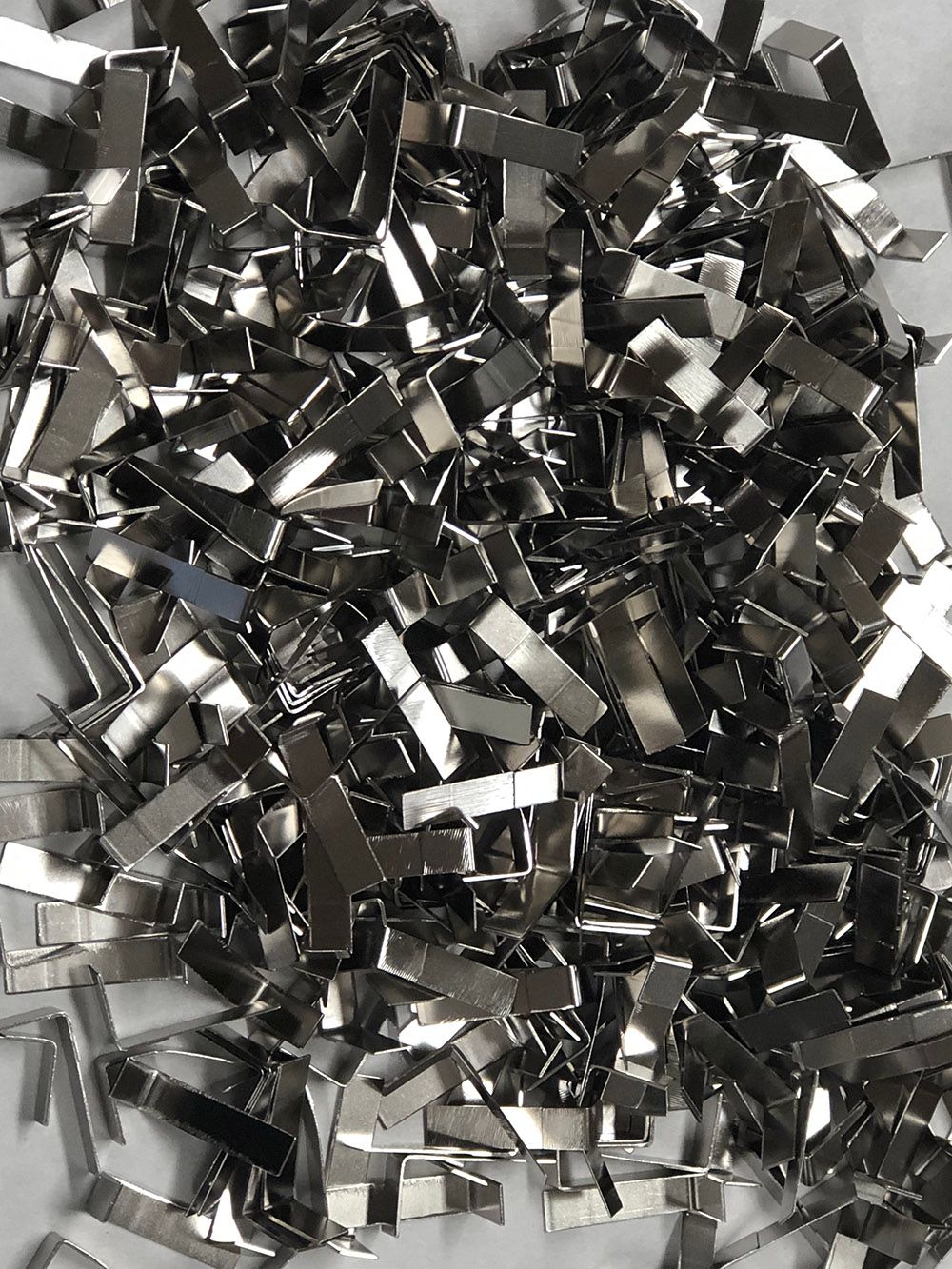 Copper battery tabs plated with bright nickel plating by Seminole Metal Finishing.