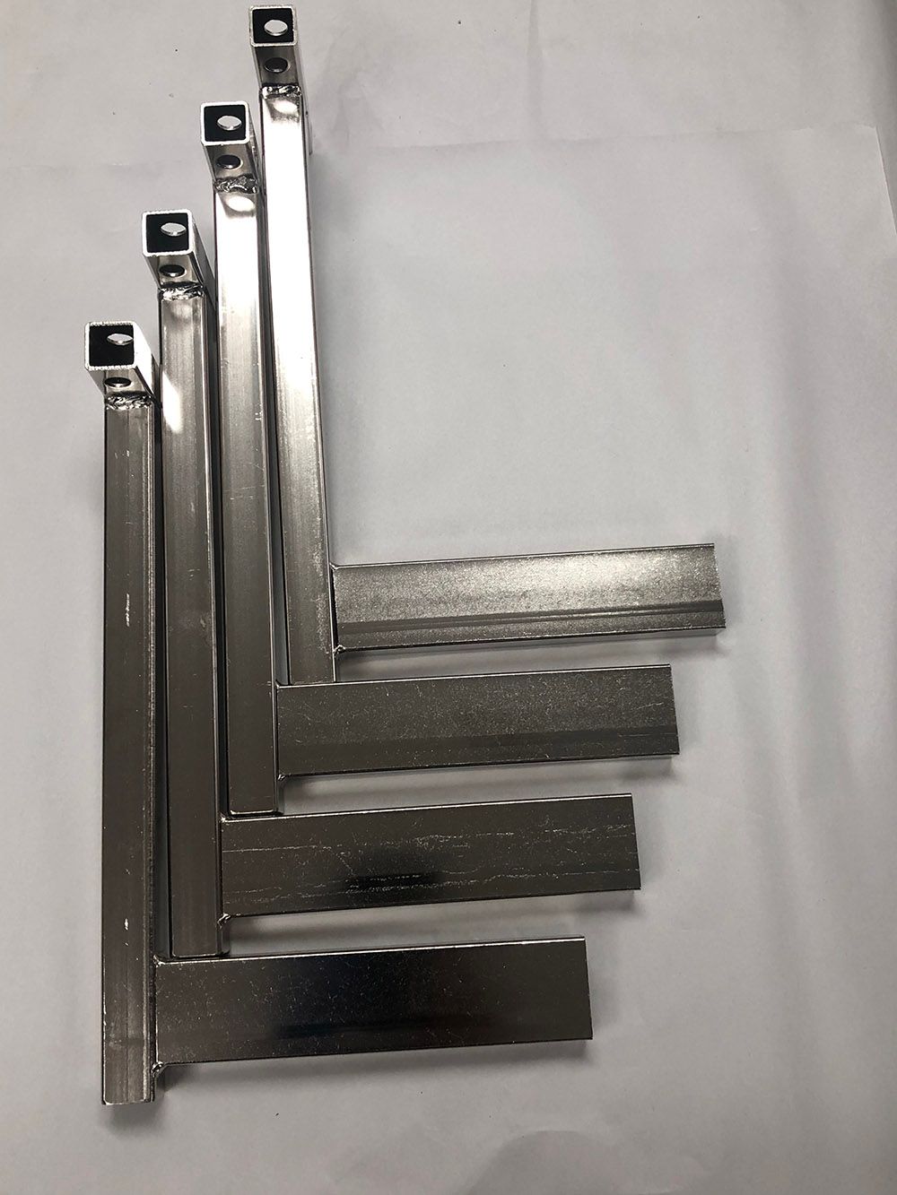 Steel adjusting arms that were electroless nickel plated by Seminole Metal Finishing.