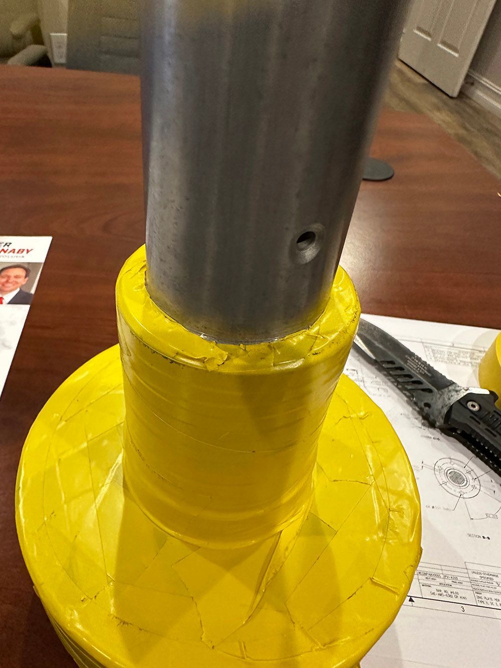 Steel shaft masked for zinc plating by Seminole Metal Finishing.