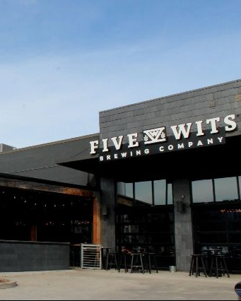Five Wits Brewing Company building with black exterior and large windows.