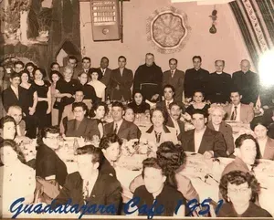 Group photo at Guadalajara Cafe, 1951. Many people, mostly well-dressed, are seated at tables and standing in a restaurant.