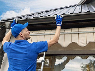 Gutter Installation — Man Installing Roof Gutter in Exton, PA
