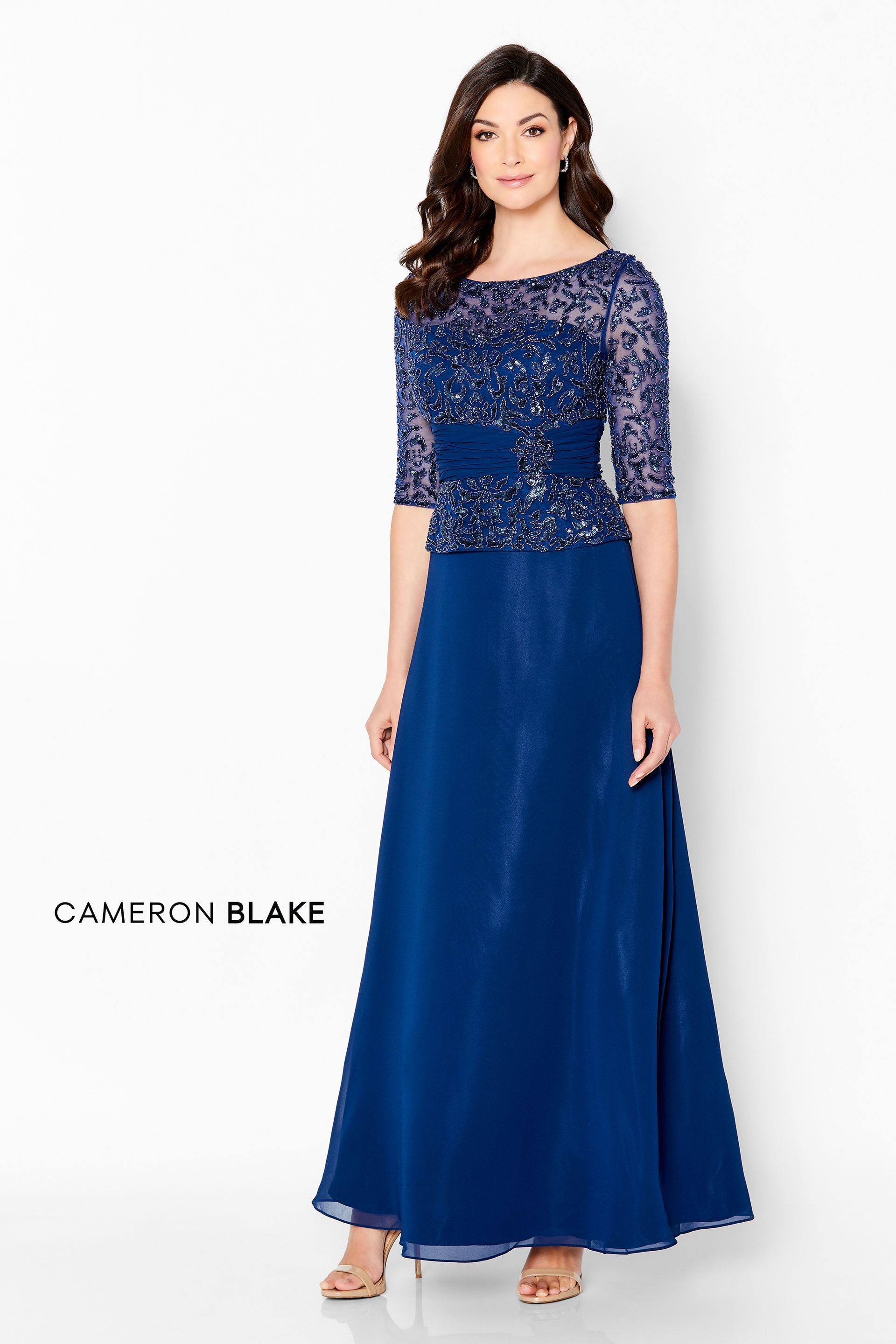 A woman is wearing a blue mother of the bride dress.