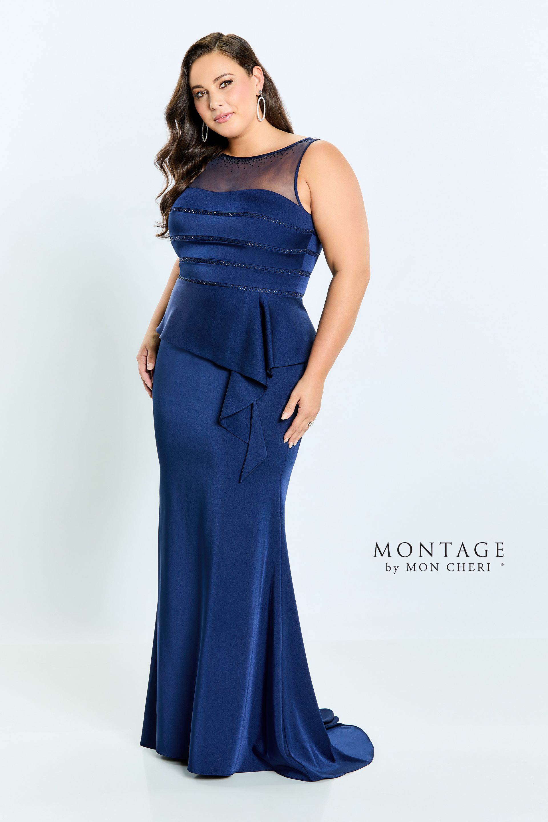 A plus size model is wearing a blue dress