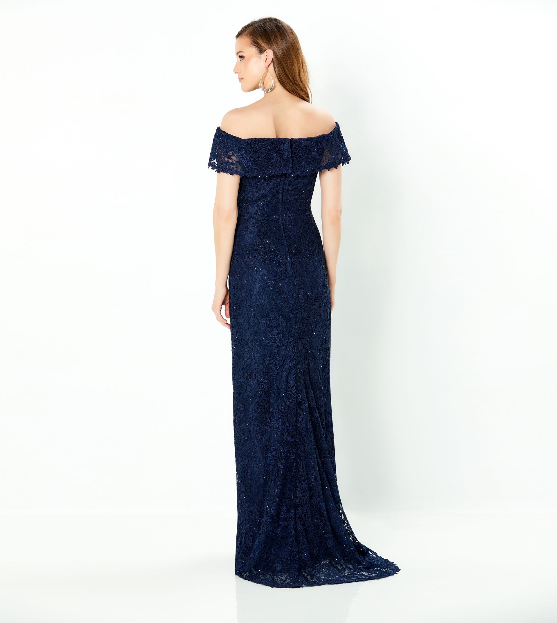 The back of a woman wearing a blue lace off the shoulder dress.