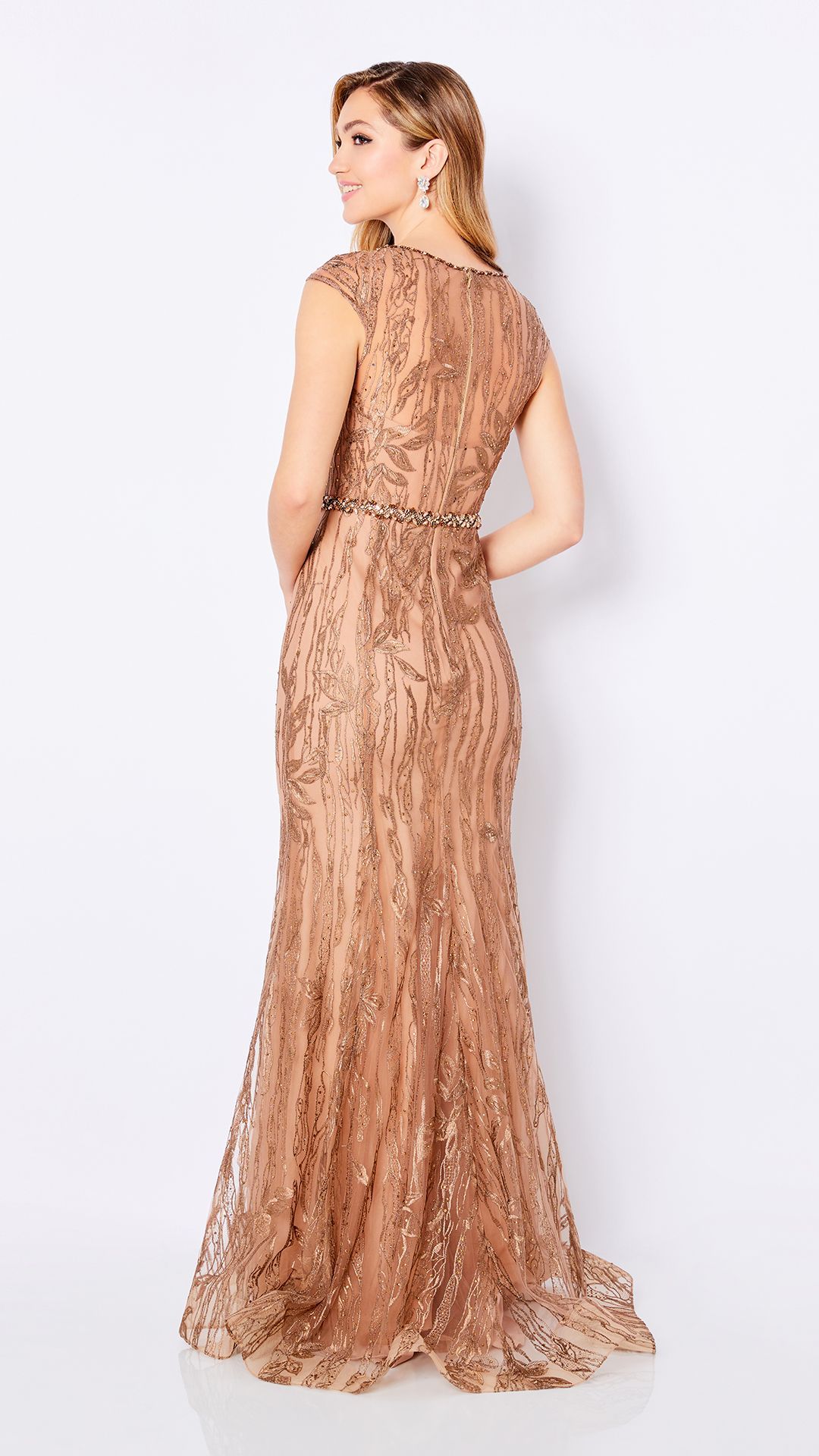The back of a woman wearing a long gold dress.