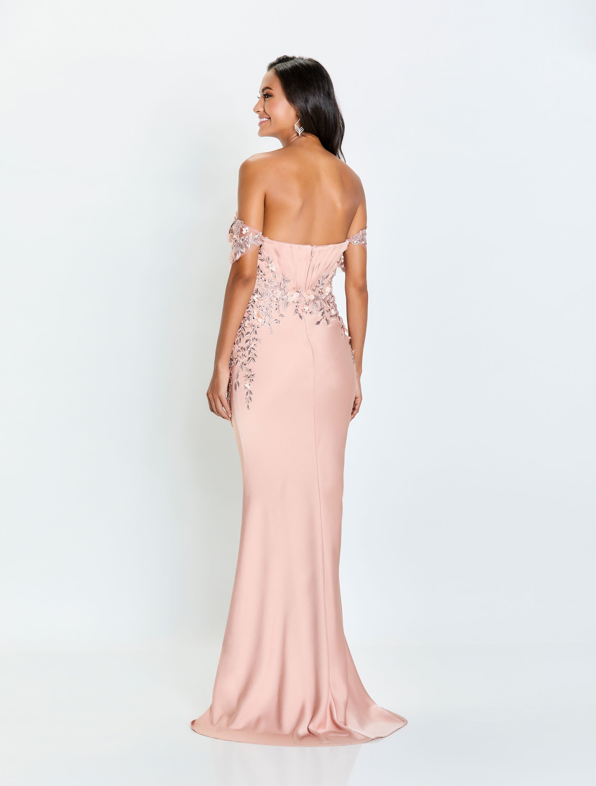 The back of a woman wearing a pink off the shoulder dress.