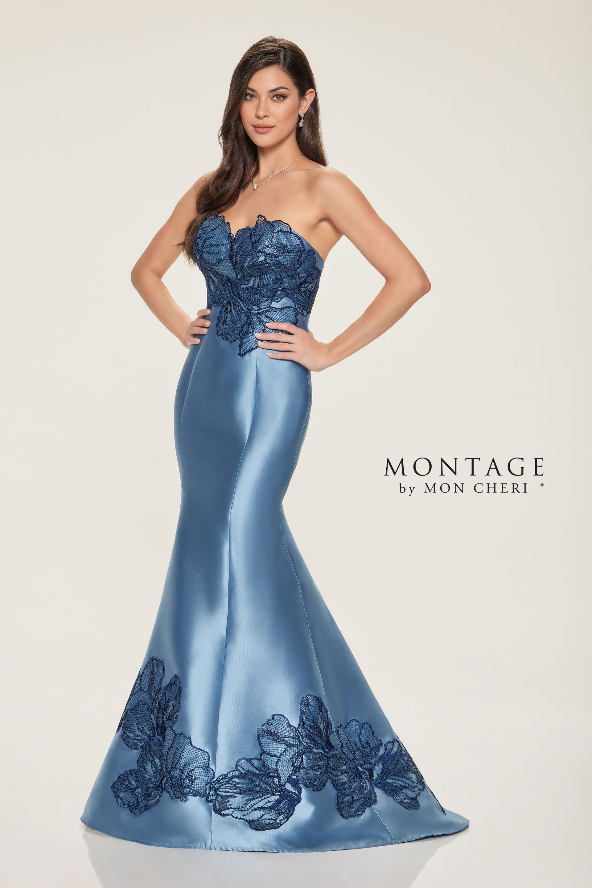 A woman is wearing a blue strapless dress