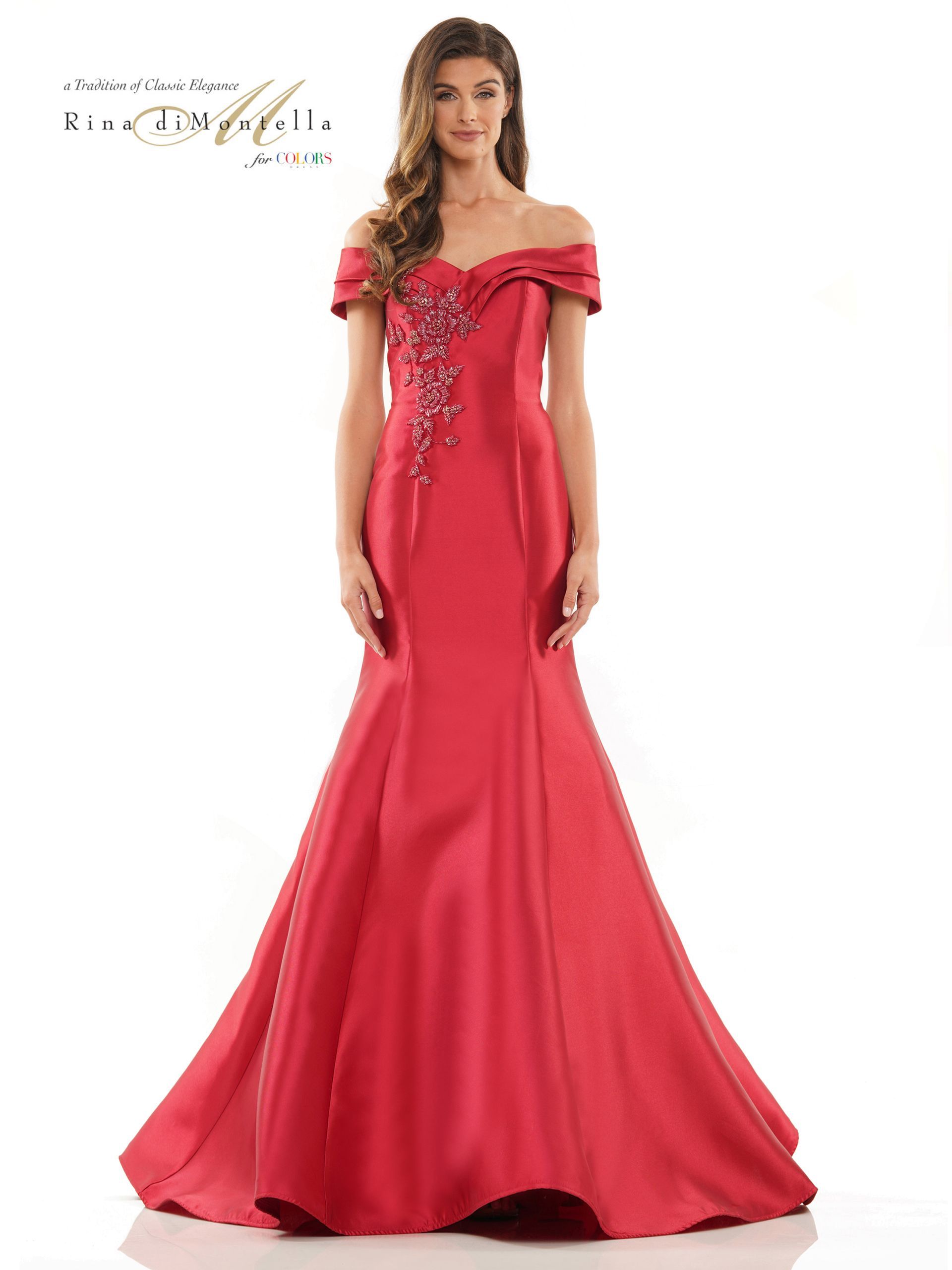 A woman is wearing a red off the shoulder dress