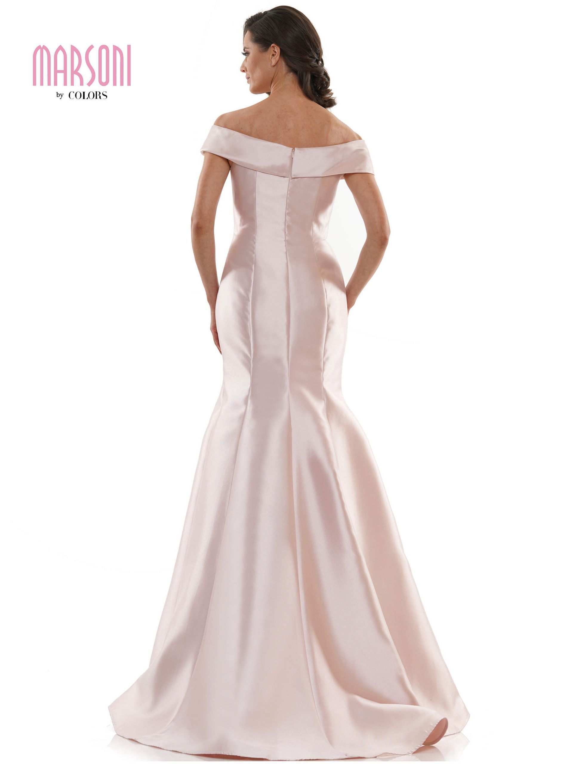 A woman is wearing a pink off the shoulder dress