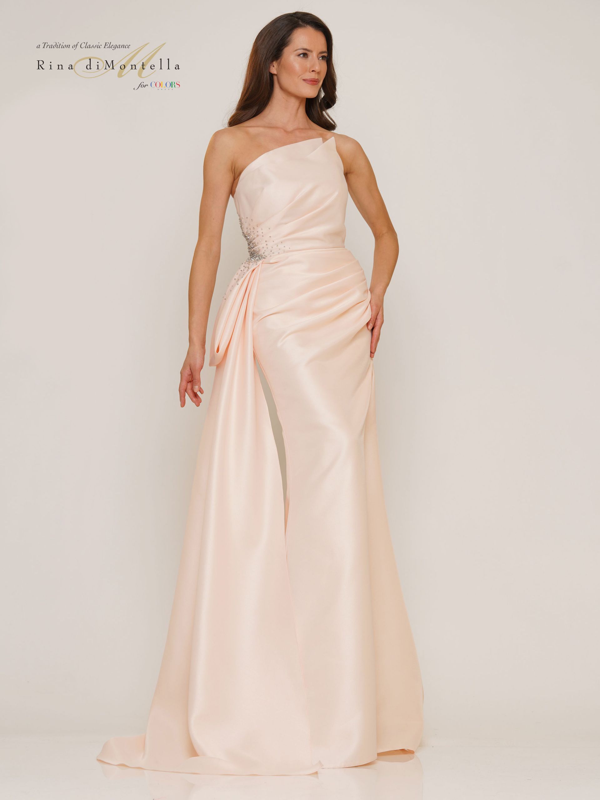 A woman is wearing a pink one shoulder dress.